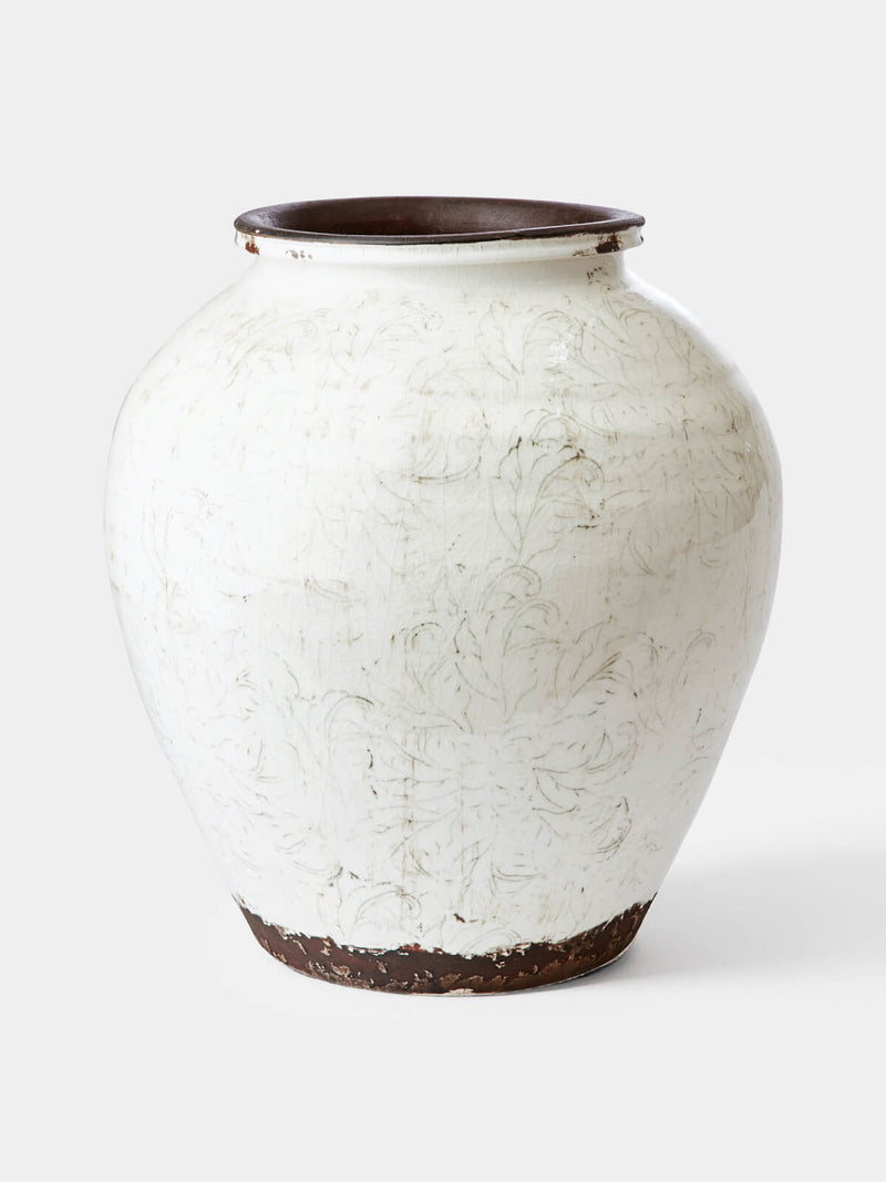 large white ceramic vase with floral details