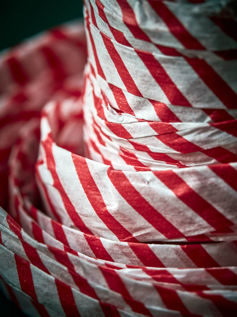 Closeup of paper ribbon in white red, festive decoration.