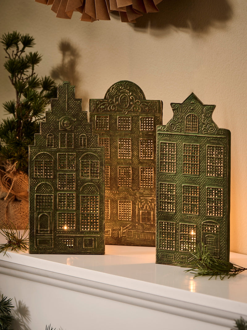 Decorative candle holders by THATCH Living shaped like Canal houses on a white surface with a neutral background