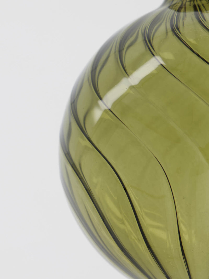 A closeup of a green bauble made from glass.