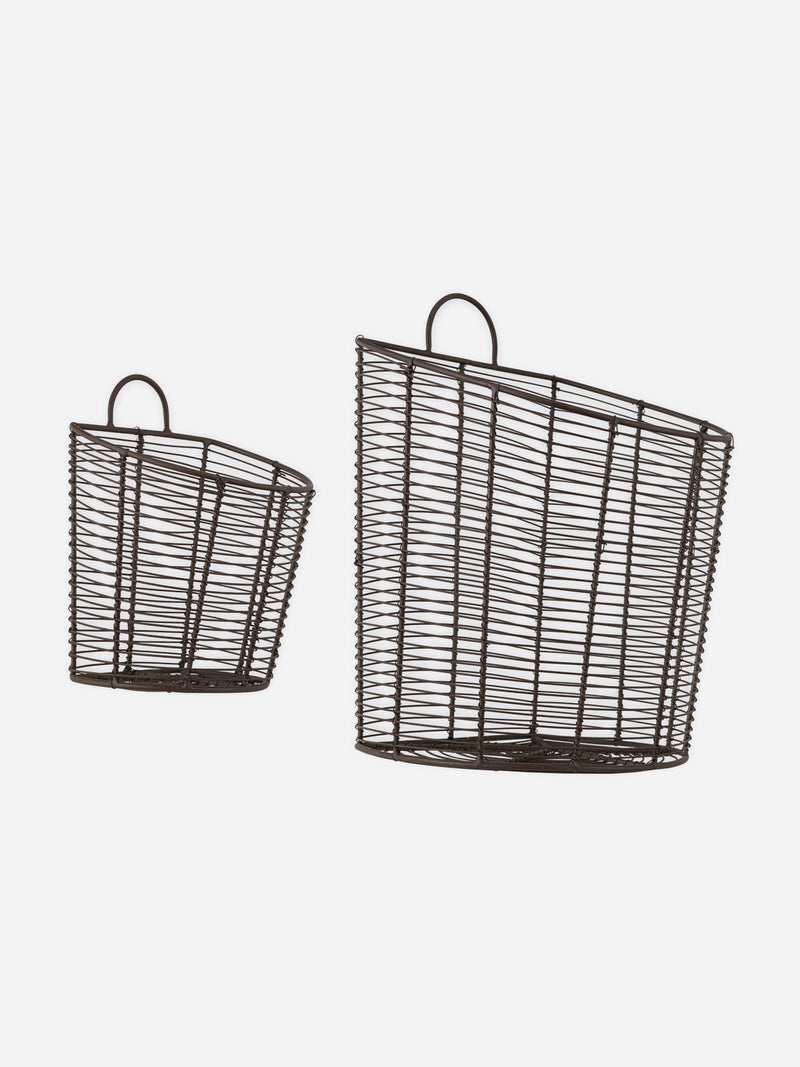 A set of two aged brass bronze wire baskets by THATCH Living with handles on a white background.