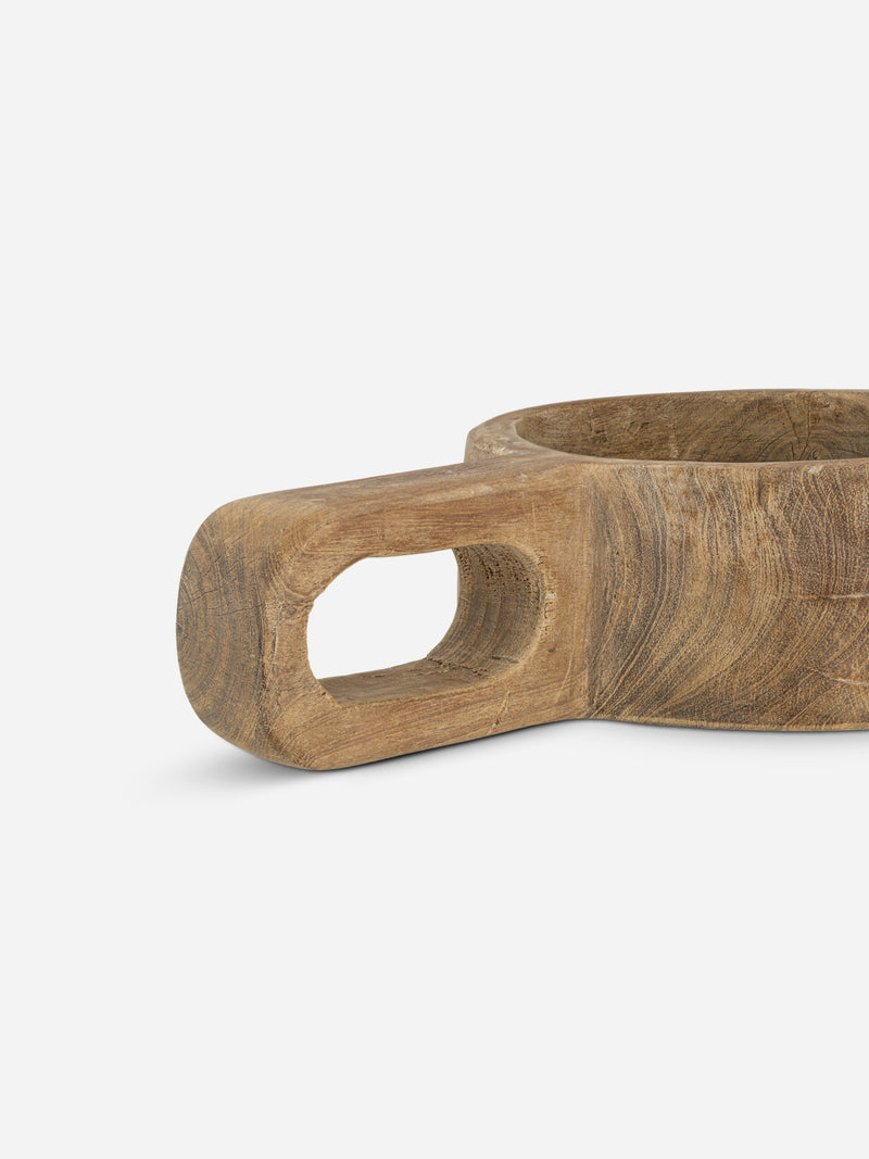 Wooden bowl with handle on a light gray background