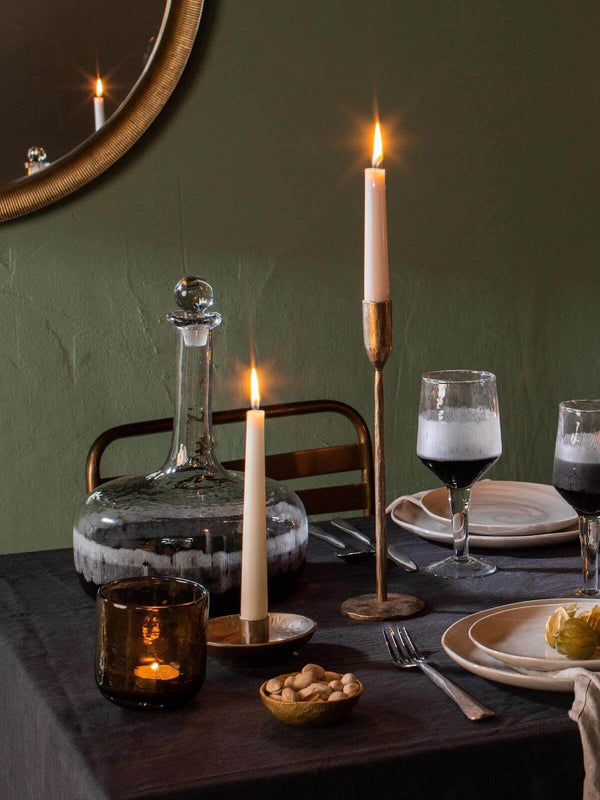 Christmas tablescape with candle light, golden accessories, wine decanter