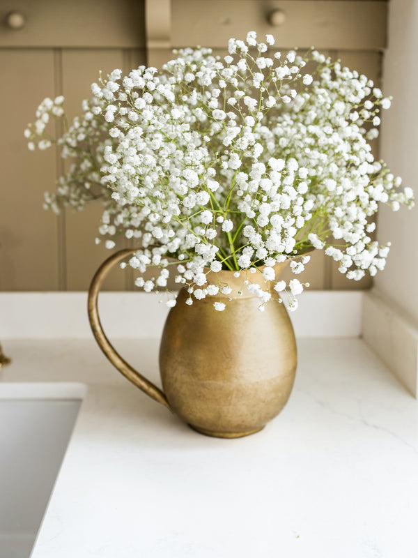 Brass Water Jug With Flowers in a kitchen setting