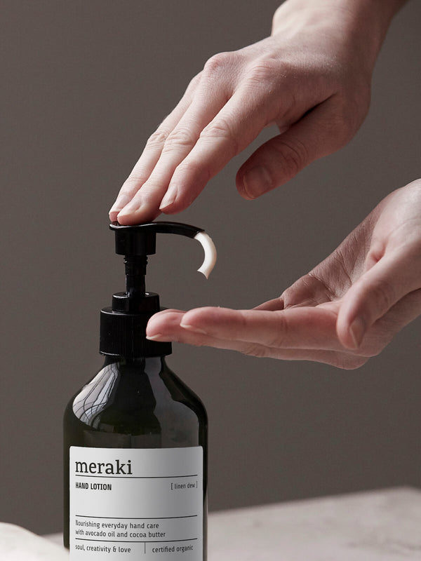 Hand squeezing Meraki linen dew bottle moisturiser hand lotion