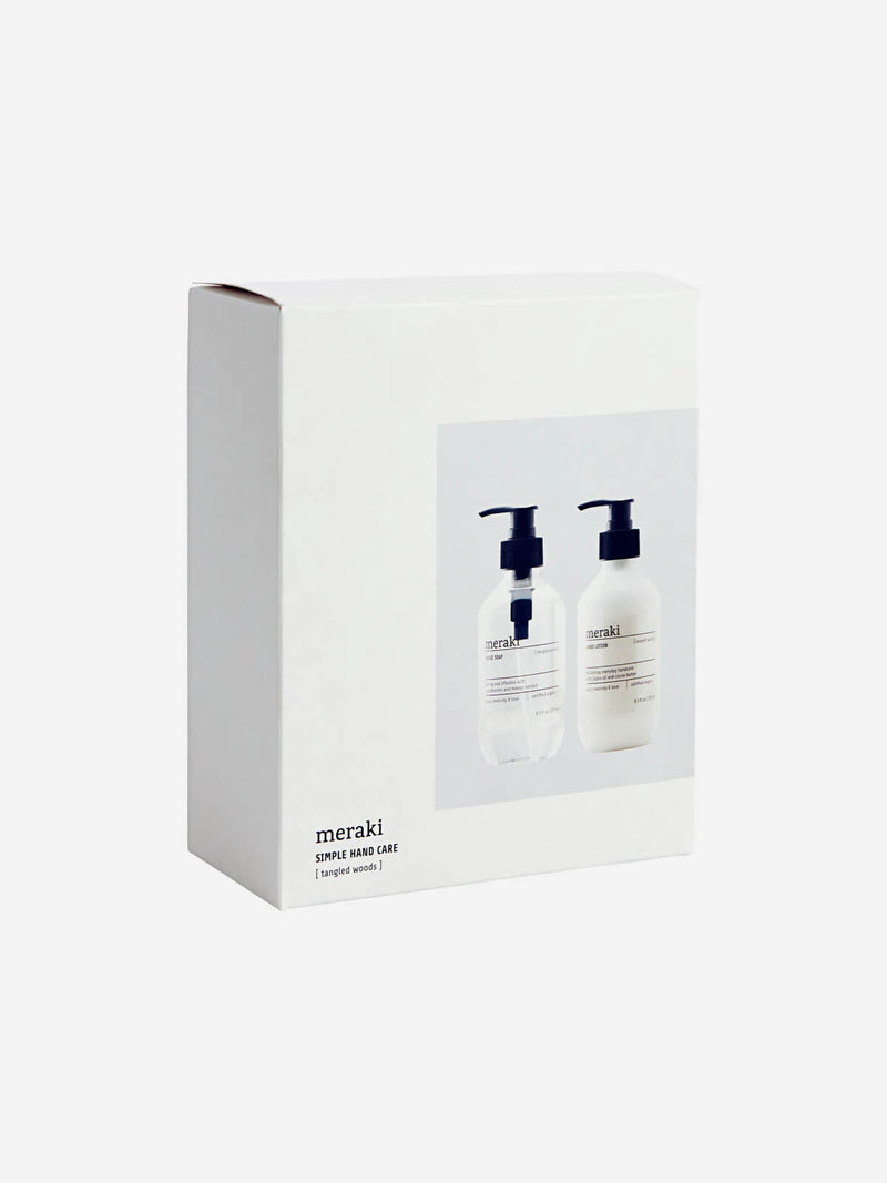White gift set box on an angle with two white bottles.