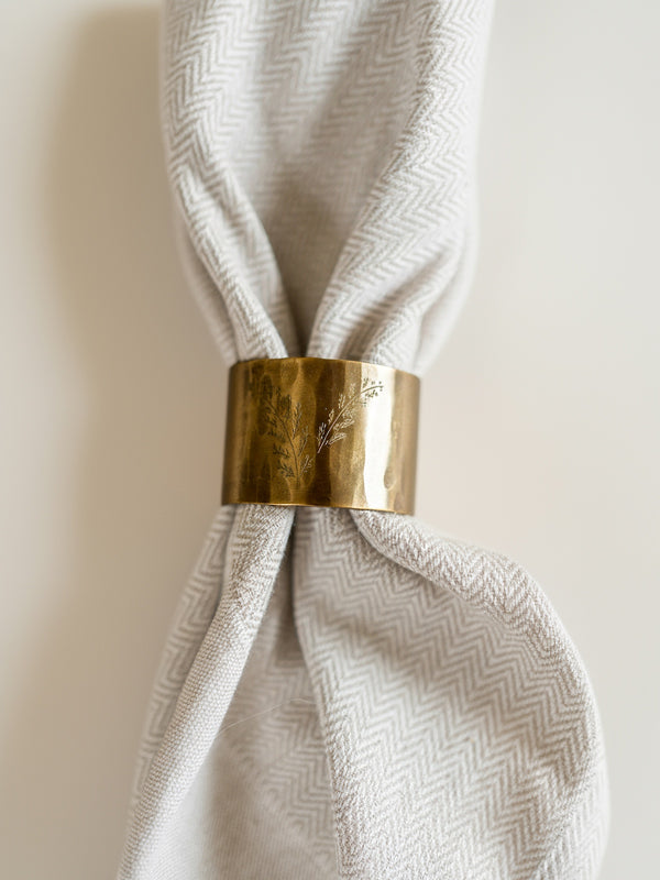 Napkin with a gold ring on a neutral background by THATCH Living