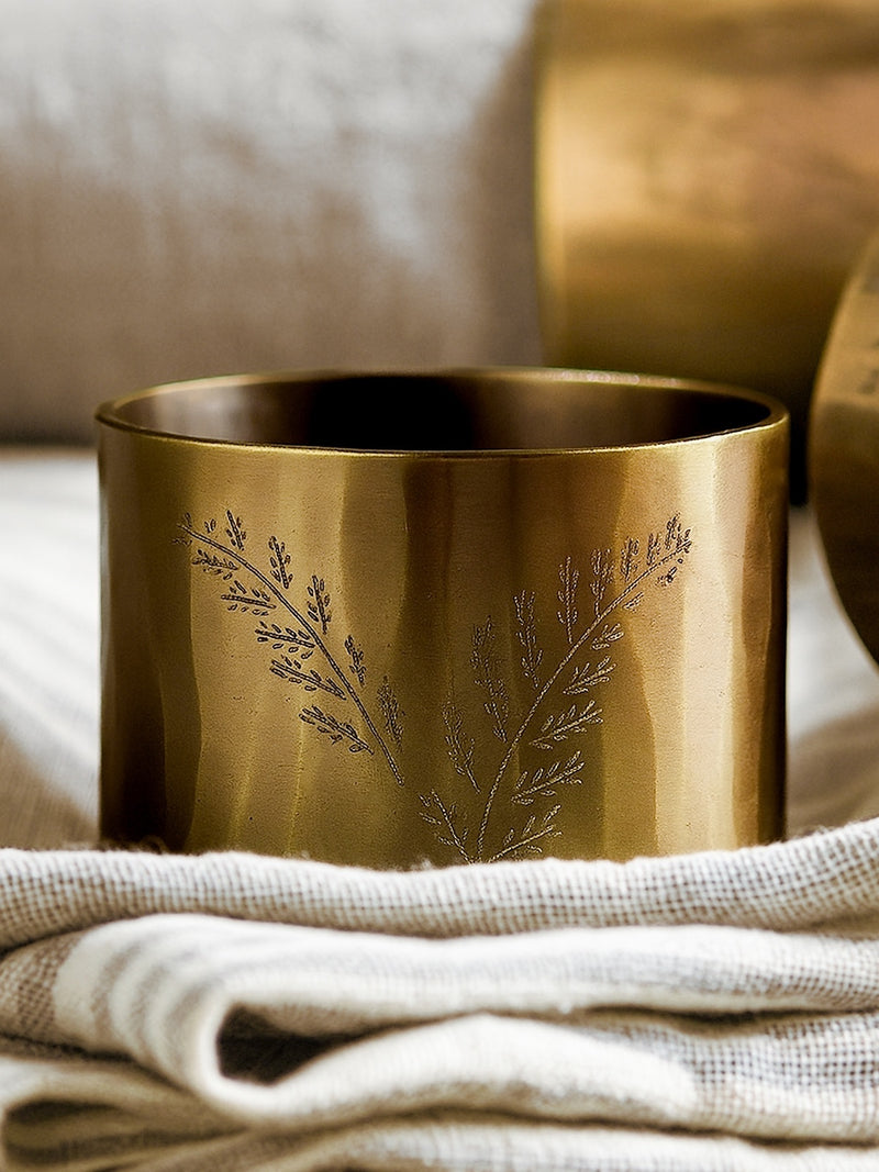Brass napkin ring with engraved design on a textured surface by THATCH Living