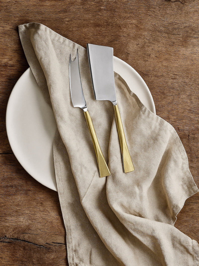 Cheese and Knife set of 2 by THATCH Living on a oak rustic table on top of white plate and linen napkins.