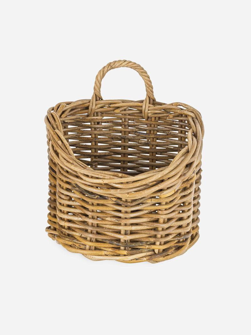 A THATCH Living wicker wall hung basket with handles on a white background