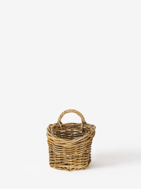 Wicker rattan basket by THATCH Living on a white background