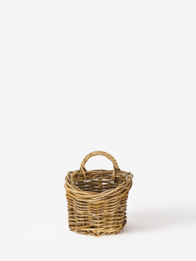 Wicker rattan basket by THATCH Living on a white background