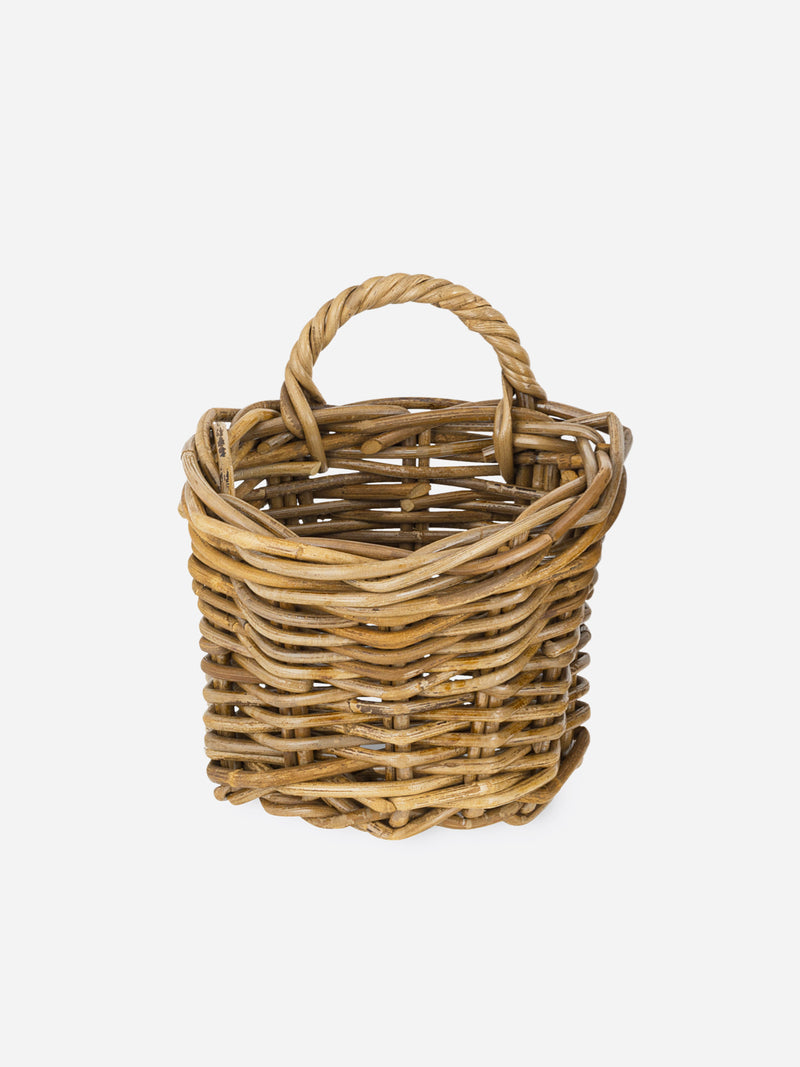 Rattan basket by THATCH Living with handle on a white background