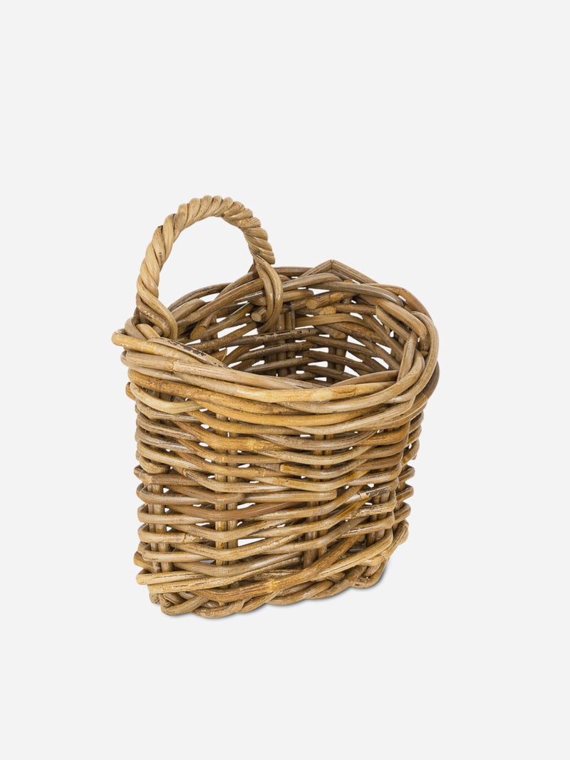 Wicker rattan basket by THATCH Living with a handle on a white background