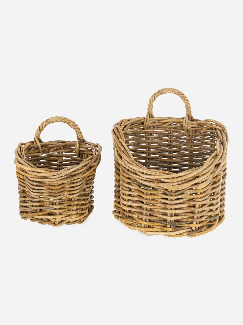 Two wicker rattan baskets by THATCH Living with handles on a white background