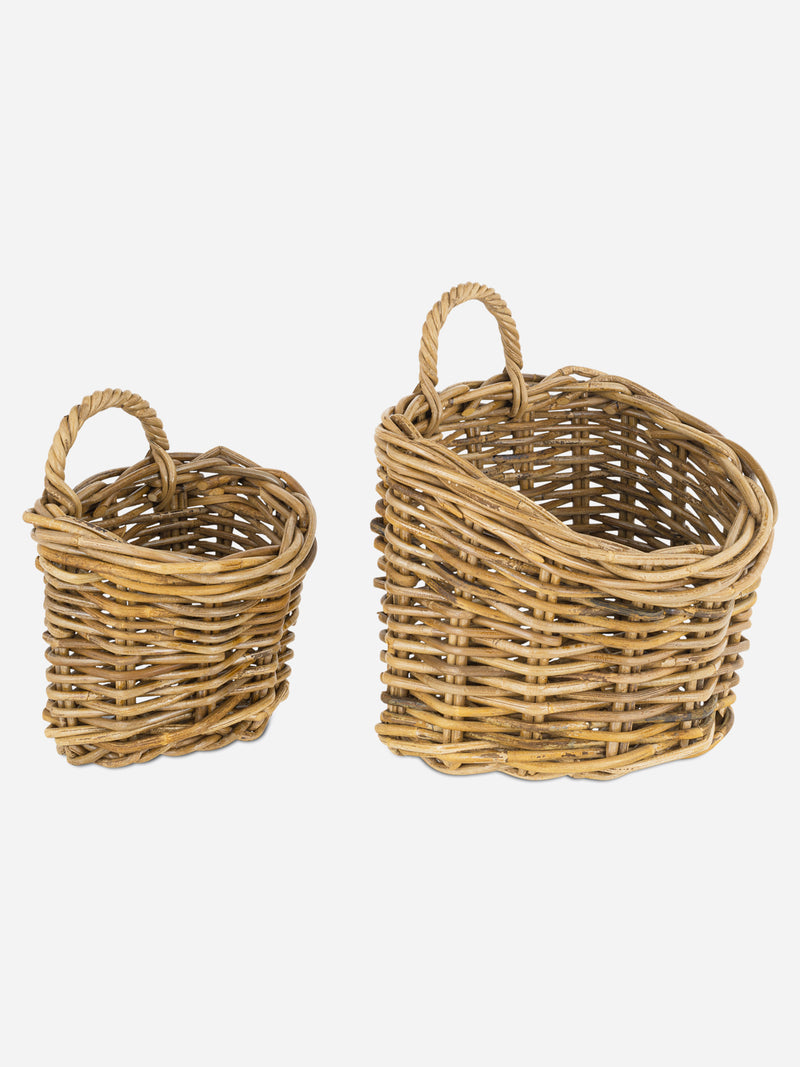 Two wicker rattan baskets by THATCH Living with handles on a white background