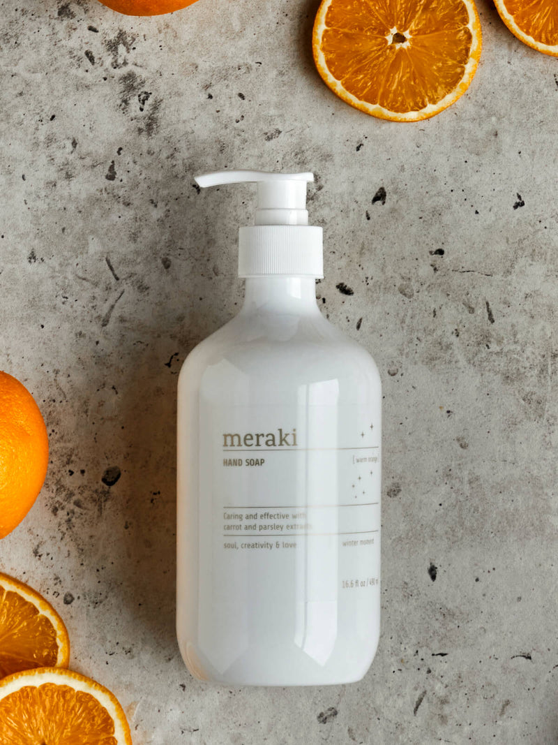 white bottle of organic hand soap surrounded by marble and oranges meraki